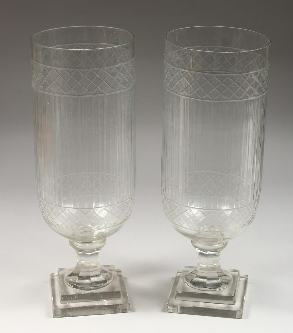 A PAIR OF CUT GLASS STORM LANTERNS. 17ins high.: A PAIR OF CUT GLASS STORM LANTERNS. 17ins high.