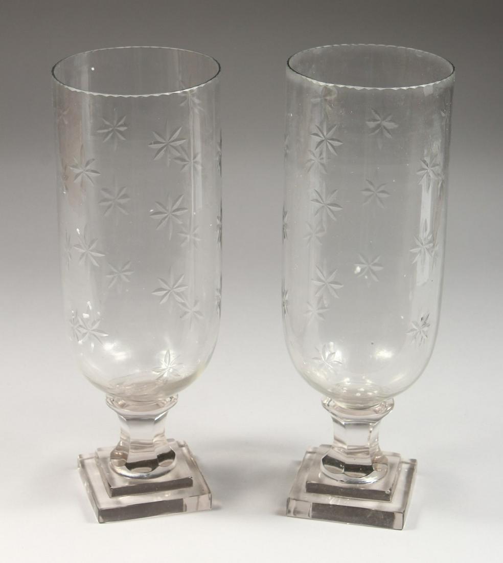 A PAIR OF CUT GLASS STORM LANTERNS. 15ins high.: A PAIR OF CUT GLASS STORM LANTERNS. 15ins high.