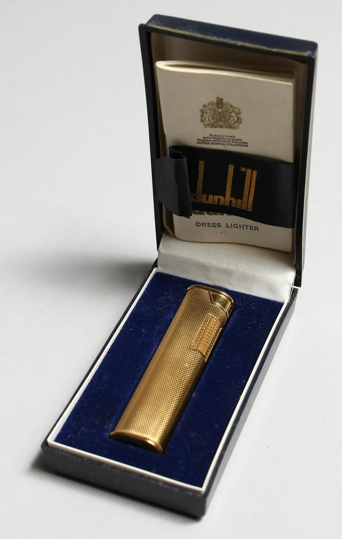 A LADIES GILT DUNHILL LIGHTER with paper in original: A LADIES GILT DUNHILL LIGHTER with paper in original box.