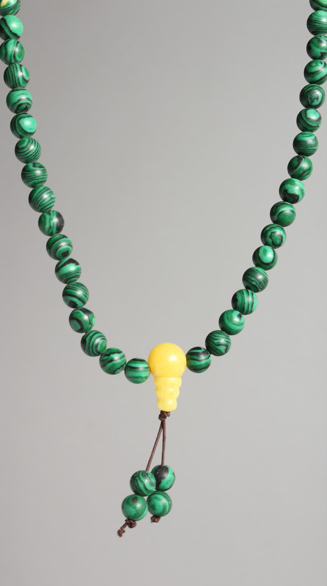 A STRING OF MALACHITE BEADS.: A STRING OF MALACHITE BEADS.