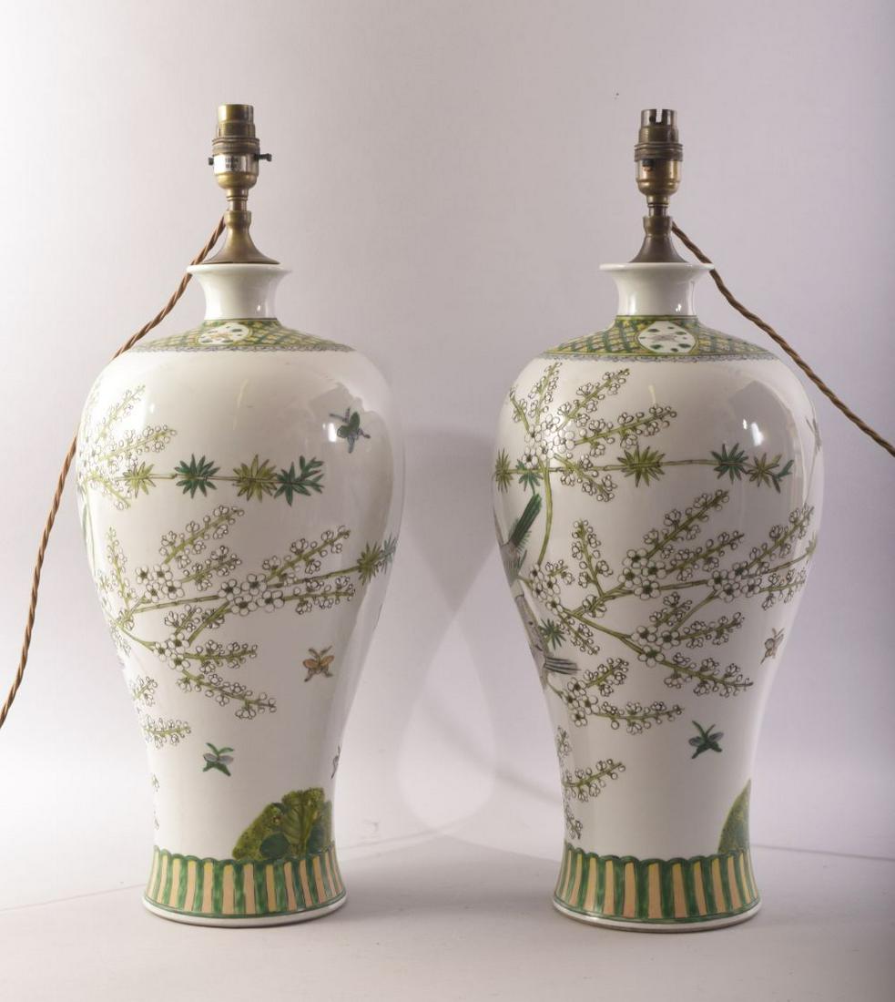 A GOOD PAIR OF CHINESE FAMILLE VERTE PORCELAIN VASE: A GOOD PAIR OF CHINESE FAMILLE VERTE PORCELAIN VASE LAMPS, undrilled, painted with birds amongst blossom, mark to each base, each approx. 52cm high.