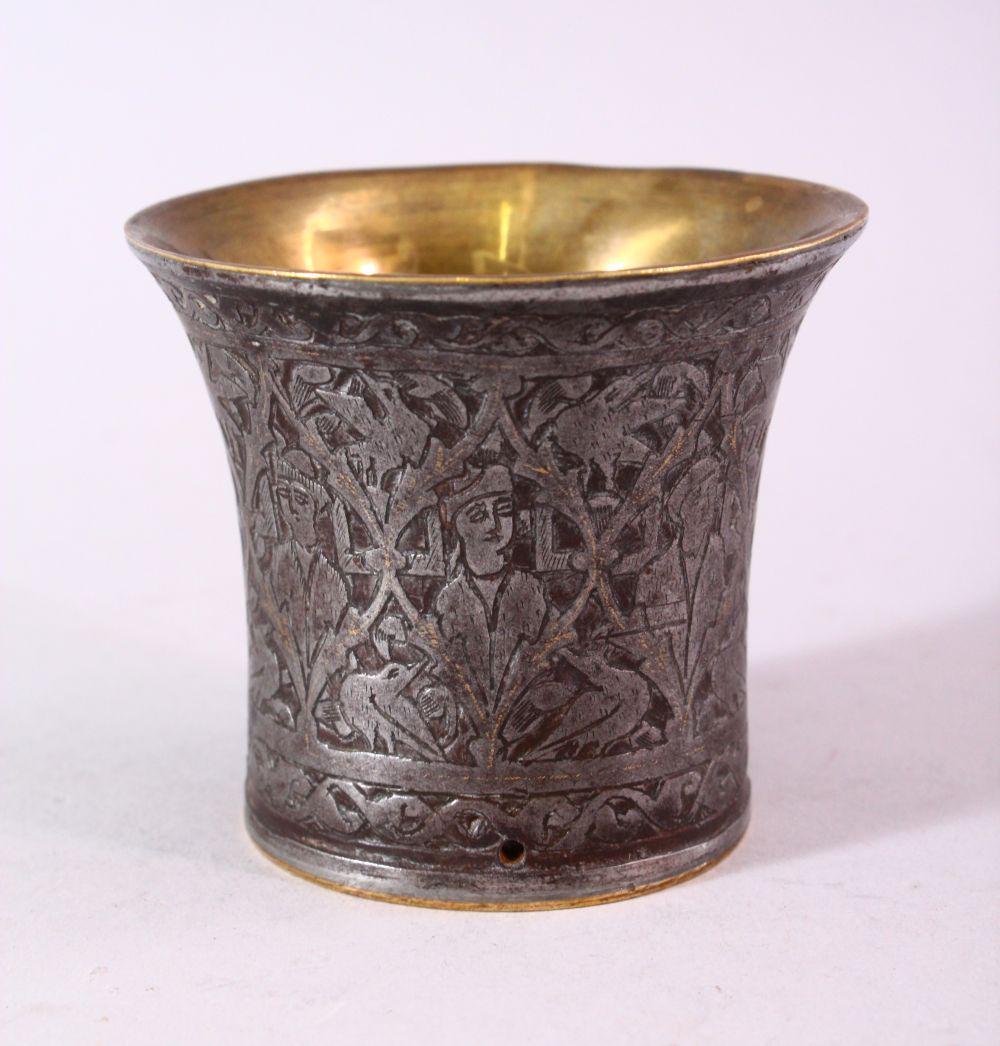 A SMALL BRASS AND ENGRAVED STEEL BEAKER SHAPED VESSEL,: A SMALL BRASS AND ENGRAVED STEEL BEAKER SHAPED VESSEL, the exterior engraved with figures, 7.5cm diameter.