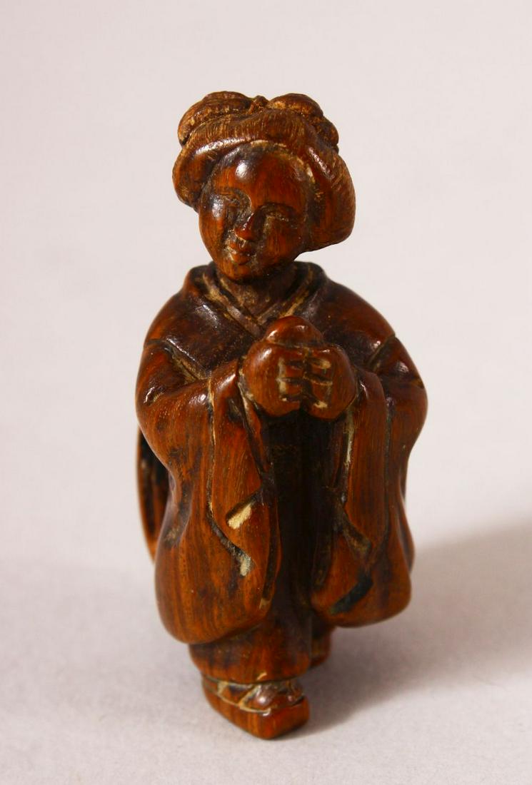 A JAPANESE MEIJI PERIOD CARVED WOOD NETSUKE OF A LADY -: A JAPANESE MEIJI PERIOD CARVED WOOD NETSUKE OF A LADY - The lady stood with her hands together, signed to her back " Tadatomo " 5cm
