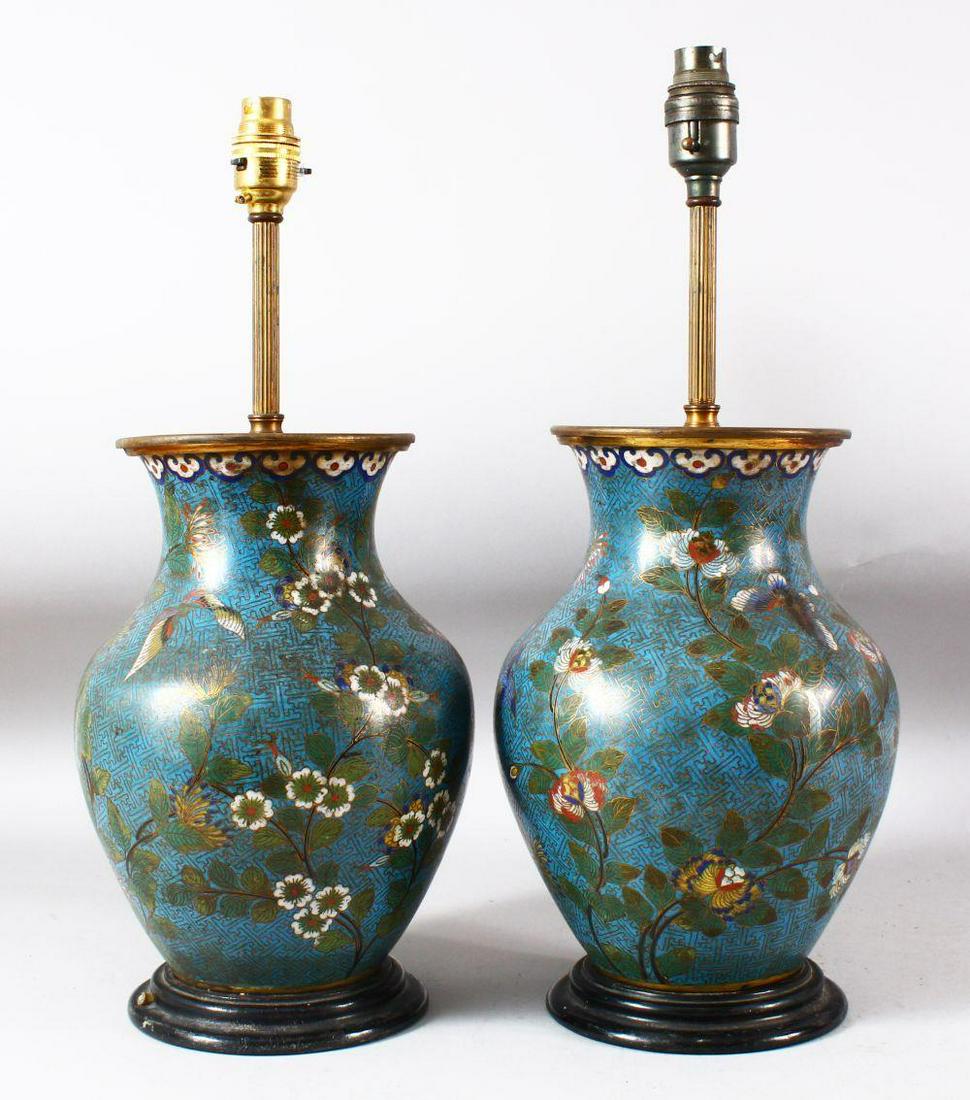 A PAIR OF CHINESE BLUE GROUND CLOISONNE VASES / LAMPS,: A PAIR OF CHINESE BLUE GROUND CLOISONNE VASES / LAMPS, decorated with native flora, butterflies and birds upon a geometric pattern, both approx. 44cm high.