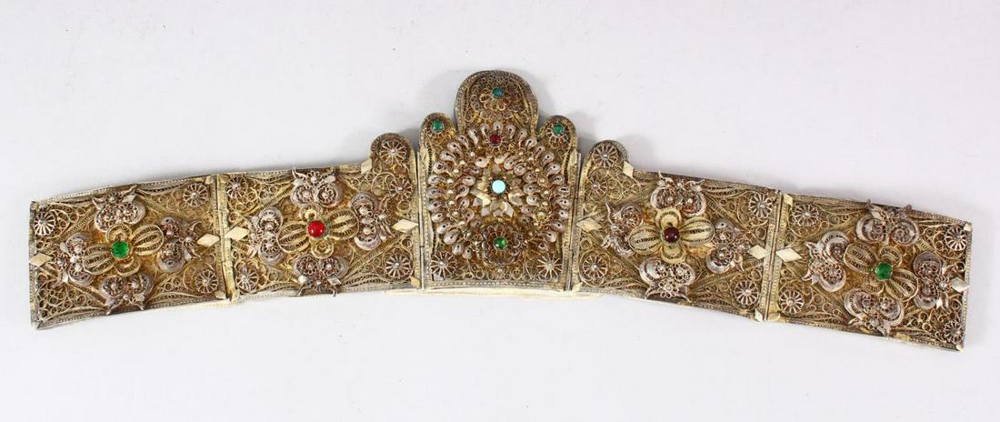 AN ISLAMIC FILIGREE BELT SECTION, with fine filigree: AN ISLAMIC FILIGREE BELT SECTION, with fine filigree work and inset with semi precious stones, 46cm long.