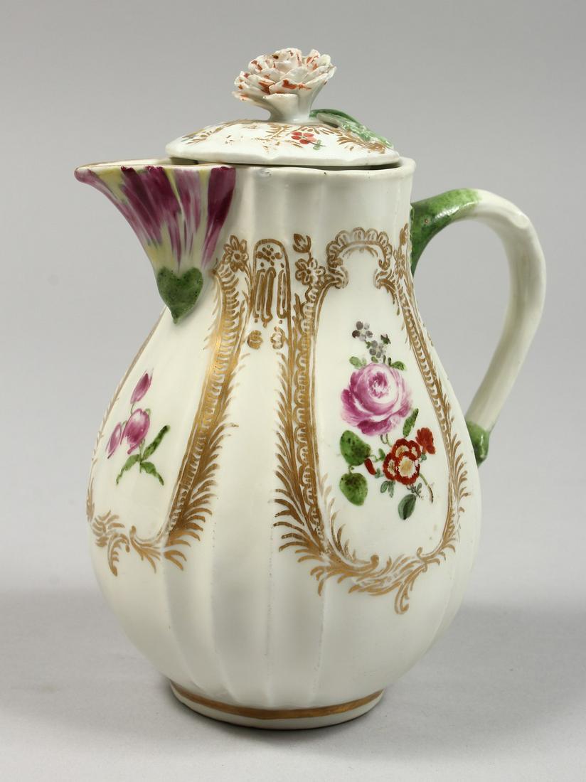 A GOOD MEISSEN RIBBED JUG AND COVER painted with: A GOOD MEISSEN RIBBED JUG AND COVER painted with flowers. Cross swords mark in blue 5.5ins high.