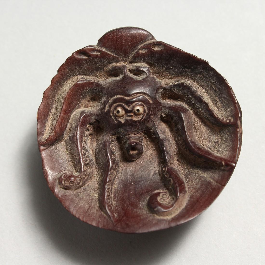 A CARVED WOOD OCTOPUS NETSUKE: A CARVED WOOD OCTOPUS NETSUKE