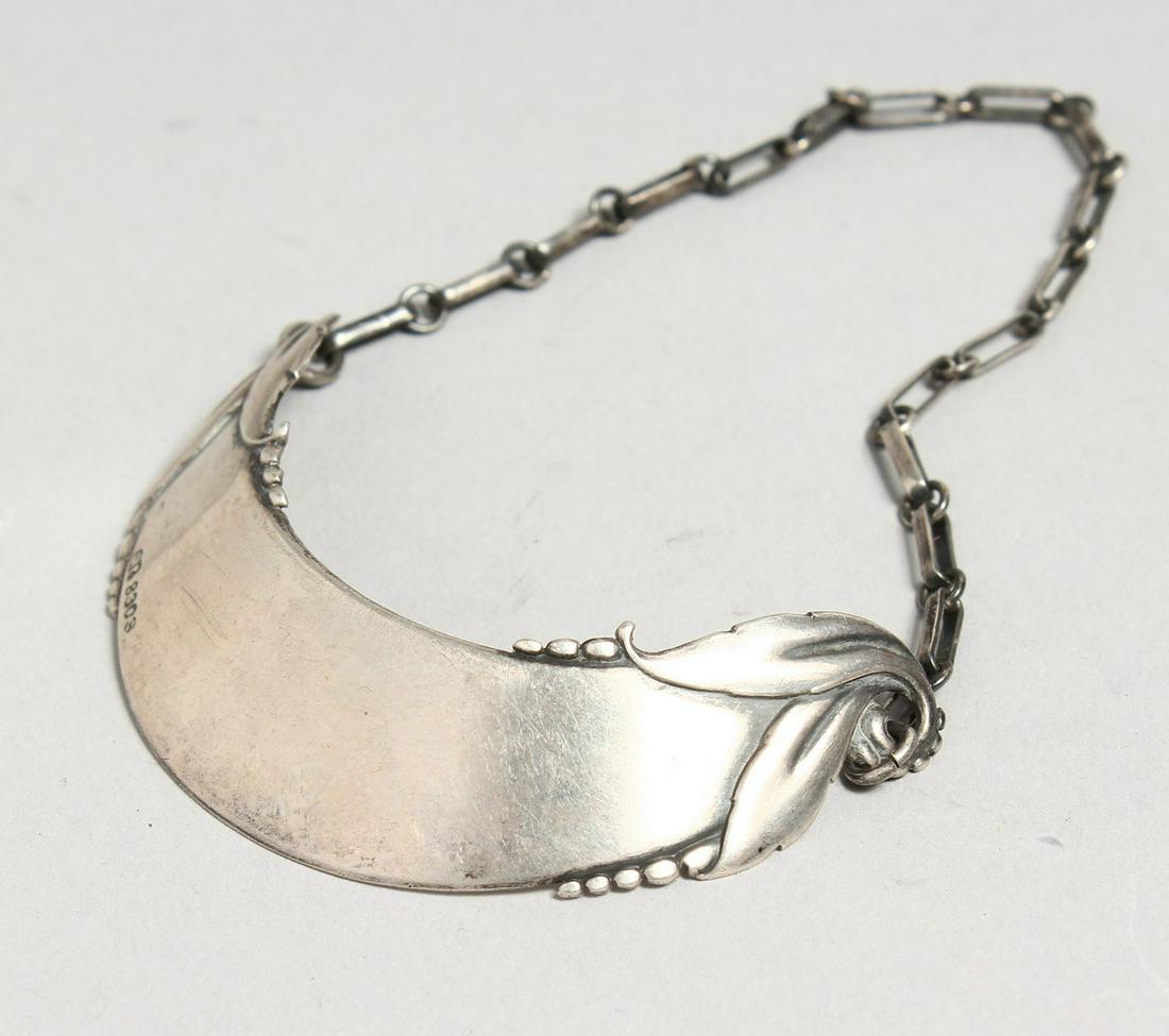 A CONTINENTAL SILVER .830 CRESCENT WINE LABEL.: A CONTINENTAL SILVER .830 CRESCENT WINE LABEL.