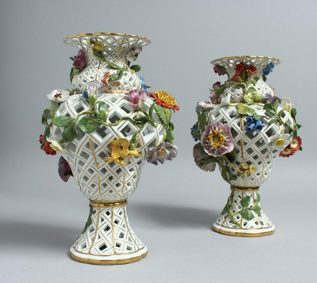 A PAIR OF MEISSEN PORCELAIN BALLUSTER SHAPED VASES,: A PAIR OF MEISSEN PORCELAIN BALLUSTER SHAPED VASES, with pierced bodies and floral encrusted decoration. 10ins high.