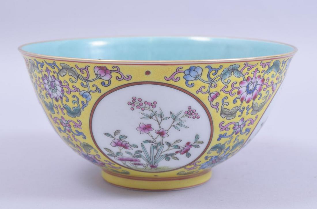 A CHINESE YELLOW GROUND FAMILLE ROSE PORCELAIN BOWL,: A CHINESE YELLOW GROUND FAMILLE ROSE PORCELAIN BOWL, decorated with circular panels of native flora and further floral motifs, the interior with turquoise, four character mark to base, 16.5cm diameter