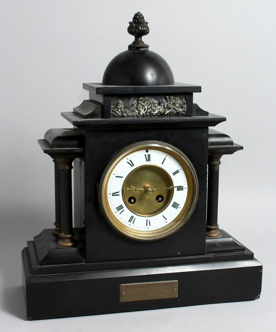 A VICTORIAN BLACK MARBLE FRENCH STRIKING MANTLE CLOCK with four columns, 15ins high, presented by: A VICTORIAN BLACK MARBLE FRENCH STRIKING MANTLE CLOCK with four columns, 15ins high, presented by Major L WAY.
