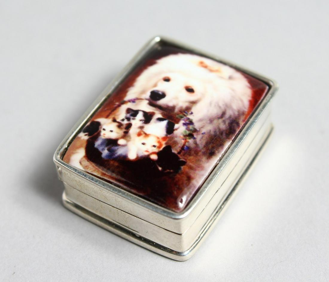 A SILVER PILL BOX, the lid decorated with a dog carrying a basket of kittens.: A SILVER PILL BOX, the lid decorated with a dog carrying a basket of kittens.