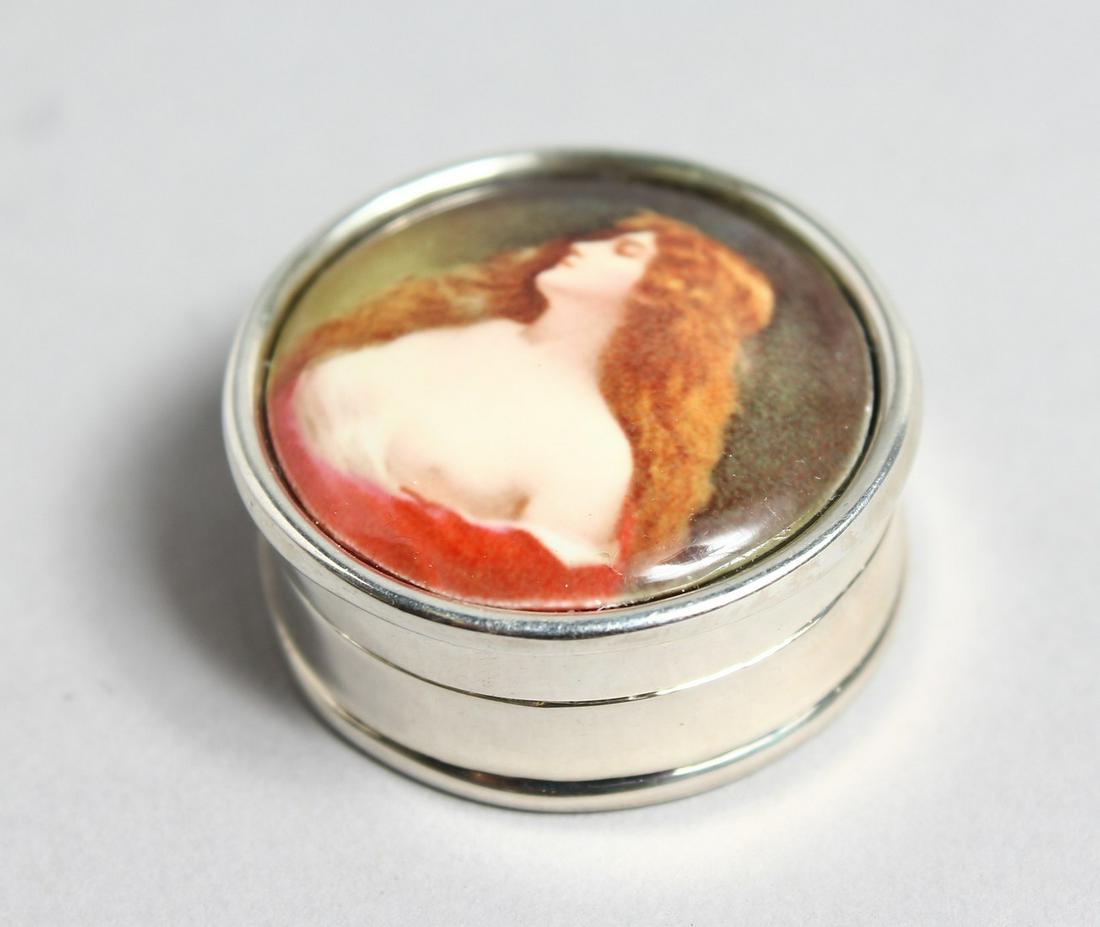 A SILVER PILL BOX the lid decorated with a young lady.: A SILVER PILL BOX the lid decorated with a young lady.