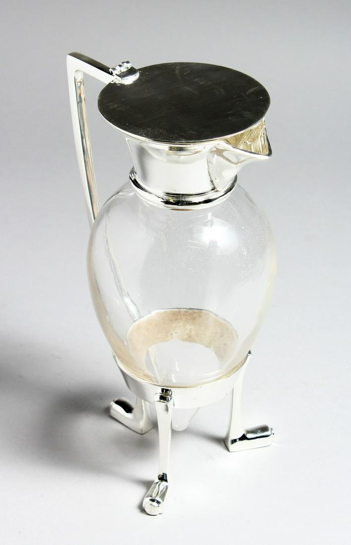 A CHRISTOPHER DRESSER STYLE GLASS CLARET JUG with plated mounts, 10.5ins high.: A CHRISTOPHER DRESSER STYLE GLASS CLARET JUG with plated mounts, 10.5ins high.