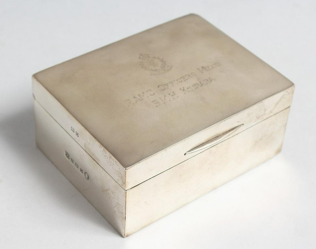 AN OBLONG SILVER CIGARETTE BOX with cedarwood liner. 4.5ins wide with inscription: RAMC OFICERS: AN OBLONG SILVER CIGARETTE BOX with cedarwood liner. 4.5ins wide with inscription: RAMC OFICERS MESS, BMH KINRARA