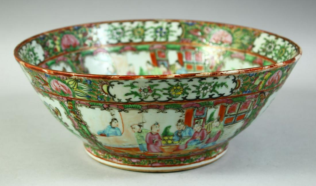 A CHINESE CANTON FAMILLE ROSE PORCELAIN BOWL, painted with panels of figures, birds and native: A CHINESE CANTON FAMILLE ROSE PORCELAIN BOWL, painted with panels of figures, birds and native flora, 28cm diameter.