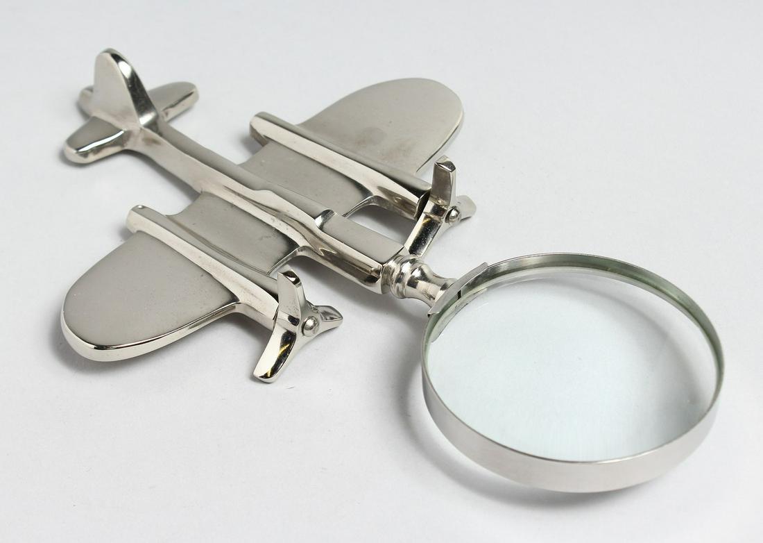 A NOVELTY CHROME PLANE MAGNIFYING GLASS.: A NOVELTY CHROME PLANE MAGNIFYING GLASS.