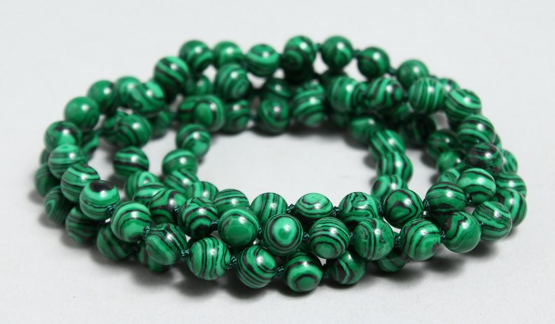 A STRING OF MALACHITE BEADS: A STRING OF MALACHITE BEADS
