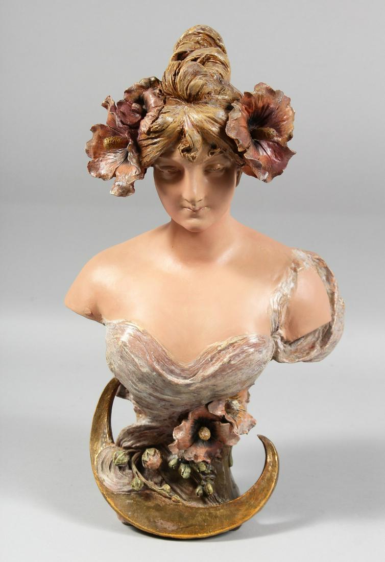 AN ART NOUVEAU POTTERY BUST. Head and shoulders of a young girl, flowers in her hair.  Signed, Ed (1 of 7)