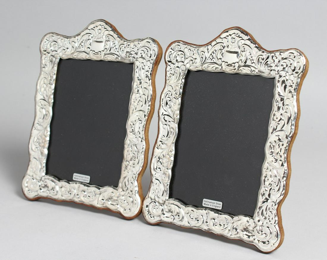 A PAIR OF SILVER PHOTOGRAPH FRAMES.  7.5ins x 5.5ins. (1 of 3)