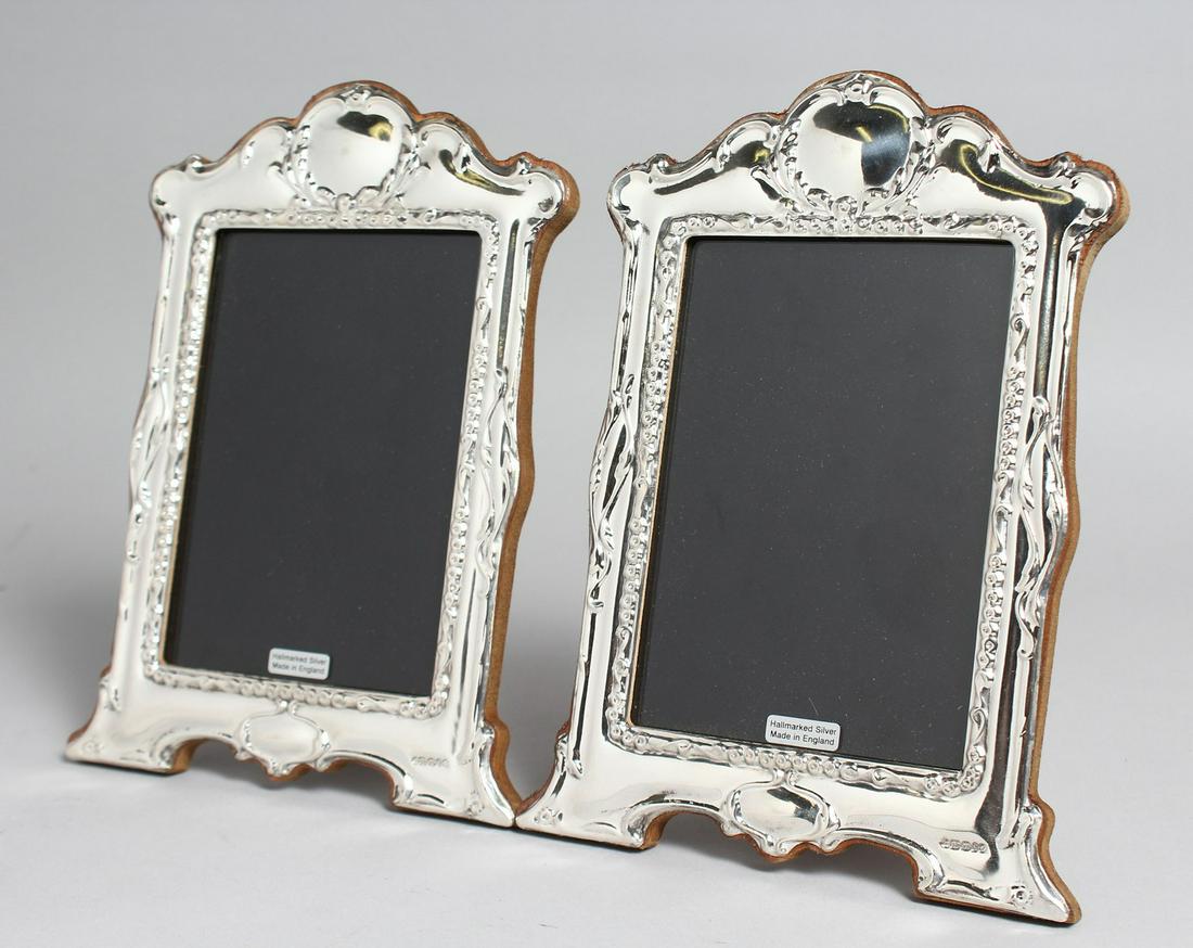 A PAIR OF SILVER PHOTOGRAPH FRAMES.  7.5ins x 5.5ins. (1 of 3)