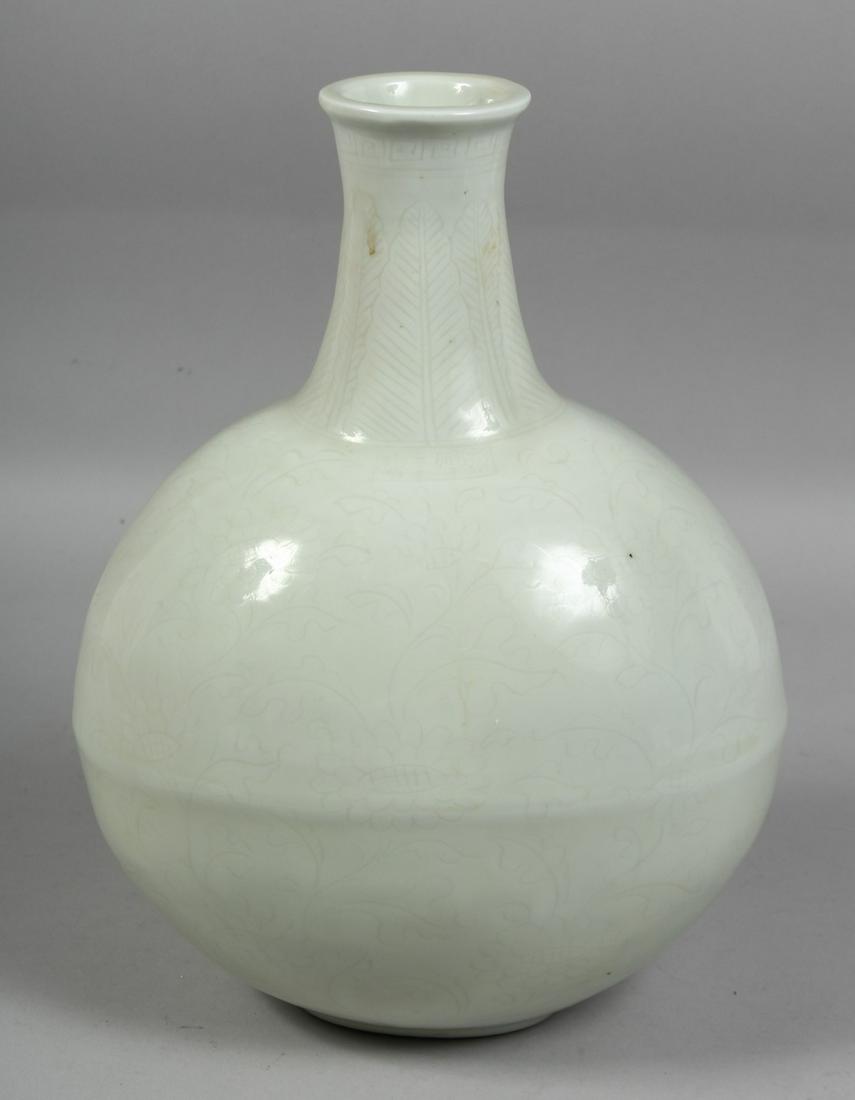 A CHINESE WHITE GLAZED PORCELAIN MOON FLASK, with incised floral decoration, with four-character: A CHINESE WHITE GLAZED PORCELAIN MOON FLASK, with incised floral decoration, with four-character mark below the neck. 32cm high.