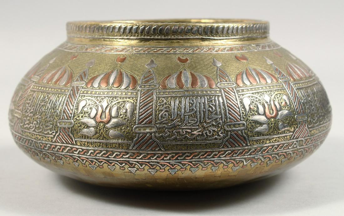 A FINE LARGE 19TH CENTURY SYRIAN DAMASCUS SILVER AND COPPER INLAID BRASS BOWL, decorated with mosque: A FINE LARGE 19TH CENTURY SYRIAN DAMASCUS SILVER AND COPPER INLAID BRASS BOWL, decorated with mosque designs and calligraphy, 22cm diameter.