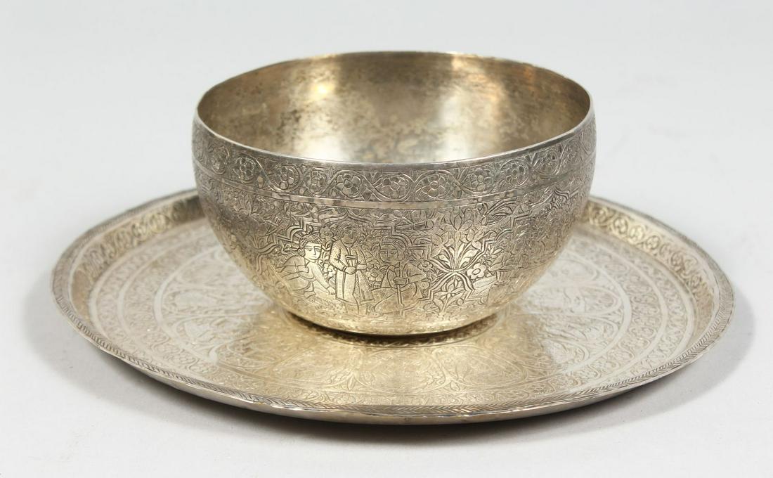 A PERSIAN QAJAR WHITE METAL BOWL AND DISH, each with engraved figural decoration, bowl 11.5cm: A PERSIAN QAJAR WHITE METAL BOWL AND DISH, each with engraved figural decoration, bowl 11.5cm diameter, dish 20.5cm diameter, (2).