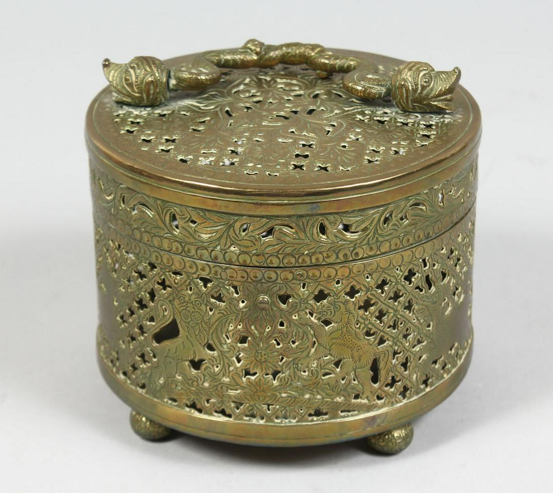 A 19TH CENTURY INDIAN BRASS OPEN WORKED BOX, depicting a British emblem, with hinged lid and handle,: A 19TH CENTURY INDIAN BRASS OPEN WORKED BOX, depicting a British emblem, with hinged lid and handle, raised on four ball feet, 12cm high.