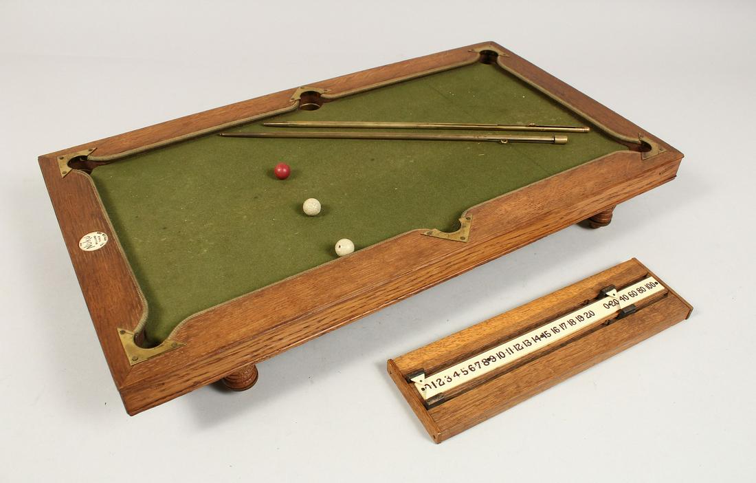 A RARE NUKU MINIATURE BILLIARD TABLE with slate base and green baize, in a fitted wooden case.: A RARE NUKU MINIATURE BILLIARD TABLE with slate base and green baize, in a fitted wooden case. 20ins long x 11ins wide.