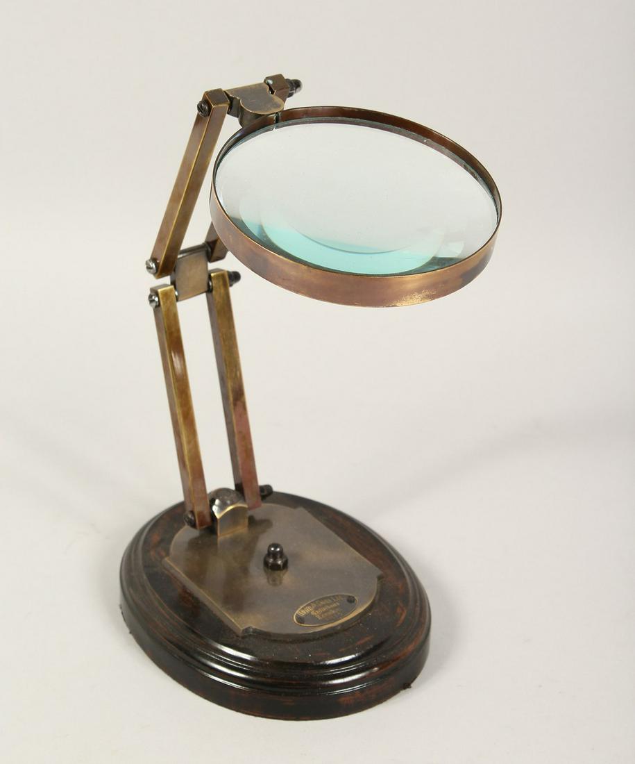 A MAGNIFYING GLASS on a stand.: A MAGNIFYING GLASS on a stand.