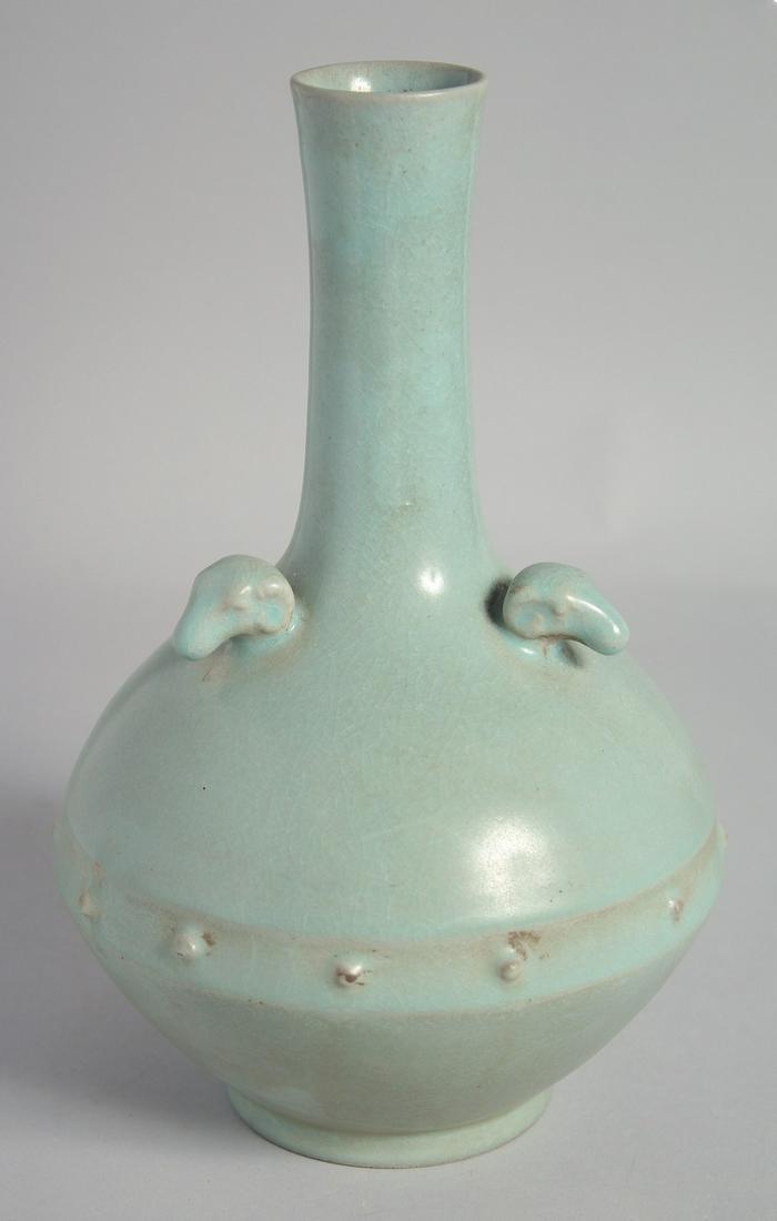 A CHINESE RU STYLE CELADON VASE, with three relief ram's heads to the shoulder, 26.5cm high. (1 of 5)