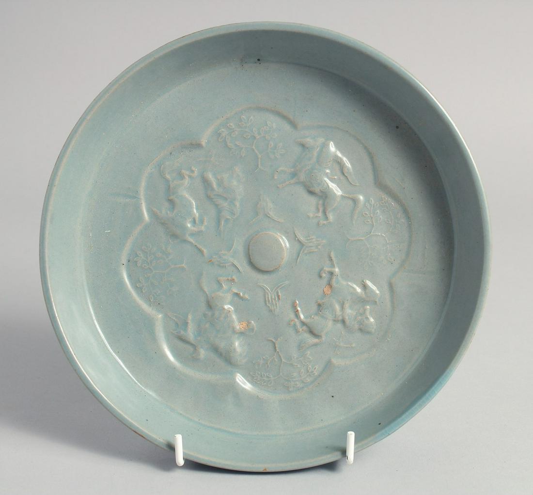 A CHINESE BLUE GLAZED CIRCULAR BRUSH WASHER, the interior centre with raised decoration depicting (1 of 2)