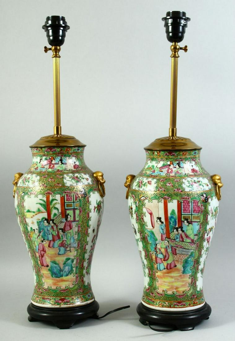 A PAIR OF CHINESE CANTON FAMILLE ROSE PORCELAIN LAMP VASES, painted with panels of figures as well (1 of 4)