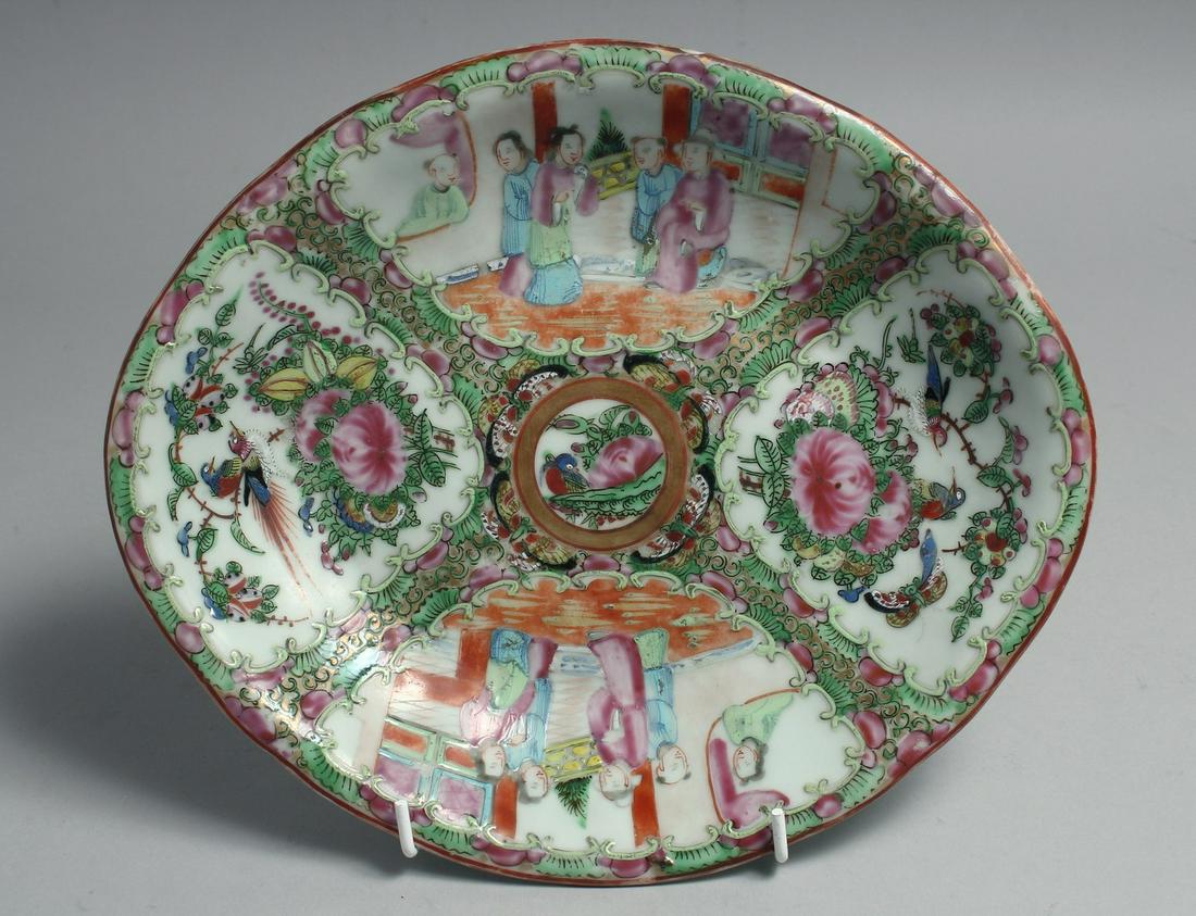 A CHINESE CANTON FAMILLE ROSE PORCELAIN DISH, painted with panels of figures, flora and fauna, (1 of 2)