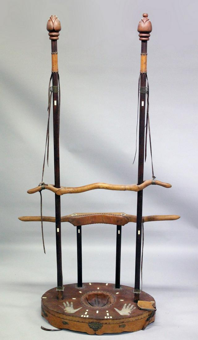 AN UNUSUAL CHINESE HARDWOOD TORTURE DEVICE, consisting of poles, leather straps and wooden yoke type: AN UNUSUAL CHINESE HARDWOOD TORTURE DEVICE, consisting of poles, leather straps and wooden yoke type devices for inverting the subject; designed to suspend the human subject.
