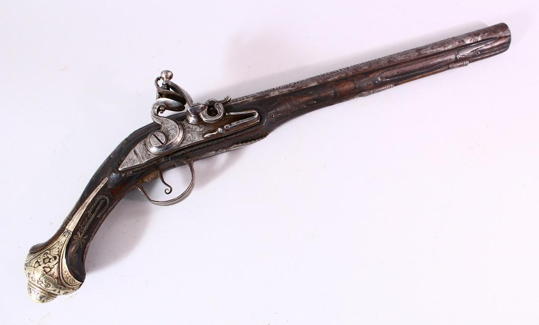 A GOOD 18TH CENTURY PERSIAN FLINTLOCK PISTOL, with engraved lockplate and barrel, silver inlaid grip: A GOOD 18TH CENTURY PERSIAN FLINTLOCK PISTOL, with engraved lockplate and barrel, silver inlaid grip with ornate buttcap, 50cm long.