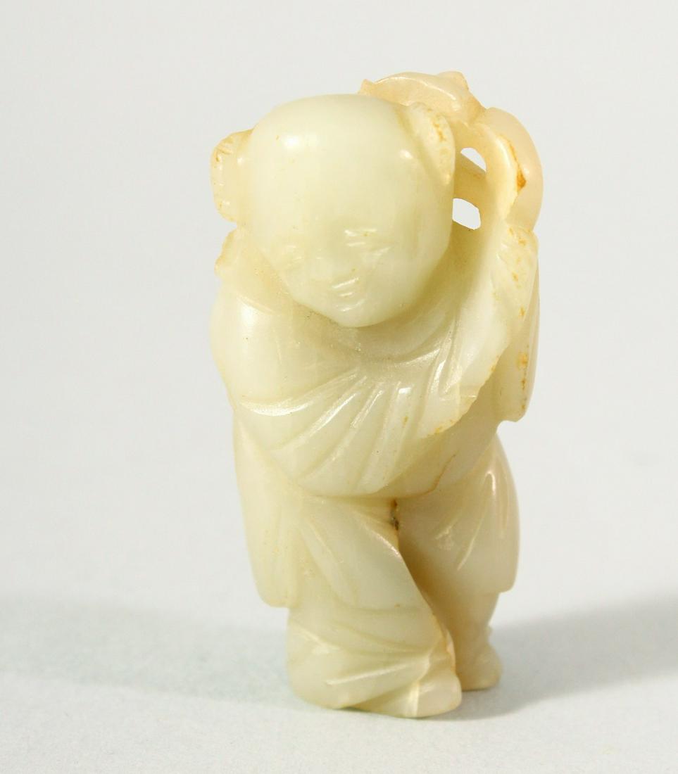 A SMALL CHINESE CARVED JADE FIGURE OF A BOY, possibly Ming Dynasty, 5.5cm high.: A SMALL CHINESE CARVED JADE FIGURE OF A BOY, possibly Ming Dynasty, 5.5cm high.