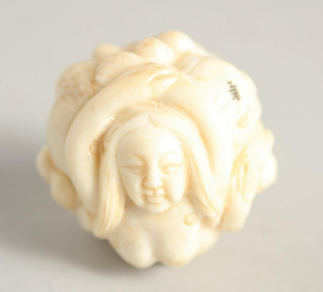 A CHINESE CARVED BALL NETSUKE "NUDE". 1.25ins diameter.: A CHINESE CARVED BALL NETSUKE "NUDE". 1.25ins diameter.