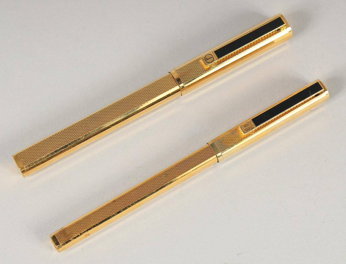 TWO DUNHILL GILT PENS, a ballpoint and fountain pen.: TWO DUNHILL GILT PENS, a ballpoint and fountain pen.