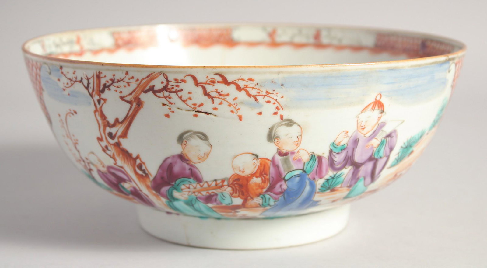 A CHINESE MANDARIN FAMILLE ROSE PORCELAIN BOWL, painted with panels of figures in an outdoor: A CHINESE MANDARIN FAMILLE ROSE PORCELAIN BOWL, painted with panels of figures in an outdoor setting, (repaired), 23cm diameter