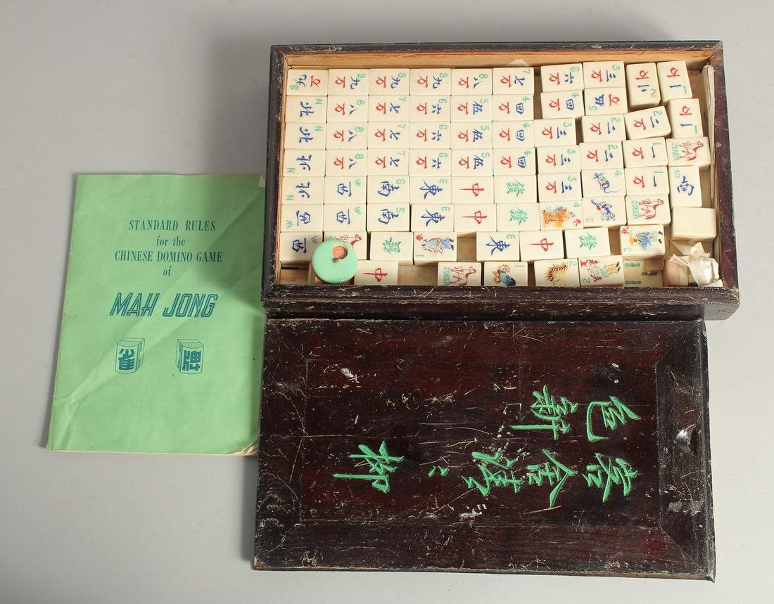 A CHINESE MAHJONG SET, with bone counters in a lidded box.: A CHINESE MAHJONG SET, with bone counters in a lidded box.