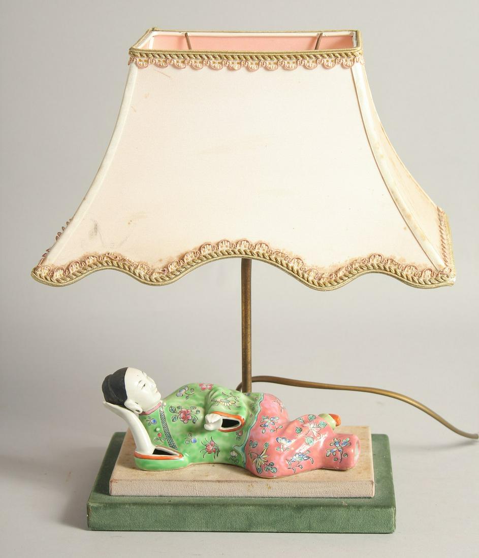 A 19TH CENTURY CHINESE FAMILLE ROSE PORCELAIN WALL FIGURE, mounted to the base of a lamp, figure,: A 19TH CENTURY CHINESE FAMILLE ROSE PORCELAIN WALL FIGURE, mounted to the base of a lamp, figure, 20cm long.