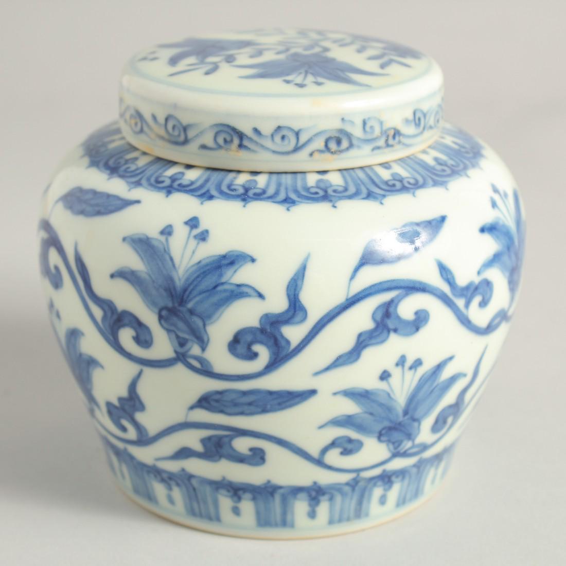 A CHINESE BLUE AND WHITE PORCELAIN JAR AND COVER painted with flora and vine. 11.5cm high: A CHINESE BLUE AND WHITE PORCELAIN JAR AND COVER painted with flora and vine. 11.5cm high