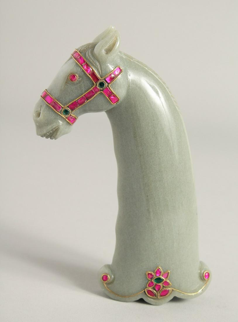 A MUGHAL STYLE CARVED JADE HORSE FORM DAGGER HANDLE, onlaid with decorative wire work and: A MUGHAL STYLE CARVED JADE HORSE FORM DAGGER HANDLE, onlaid with decorative wire work and semi-precious stones, 15cm long.