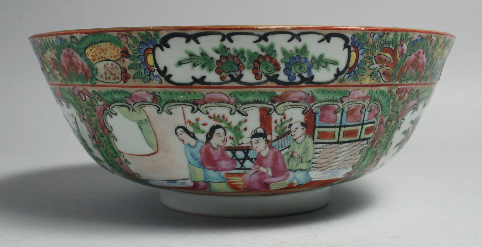 A CHINESE CANTON FAMILLE ROSE PORCELAIN BOWL, painted with panels of figures, birds and native: A CHINESE CANTON FAMILLE ROSE PORCELAIN BOWL, painted with panels of figures, birds and native flora, 23.5cm diameter.
