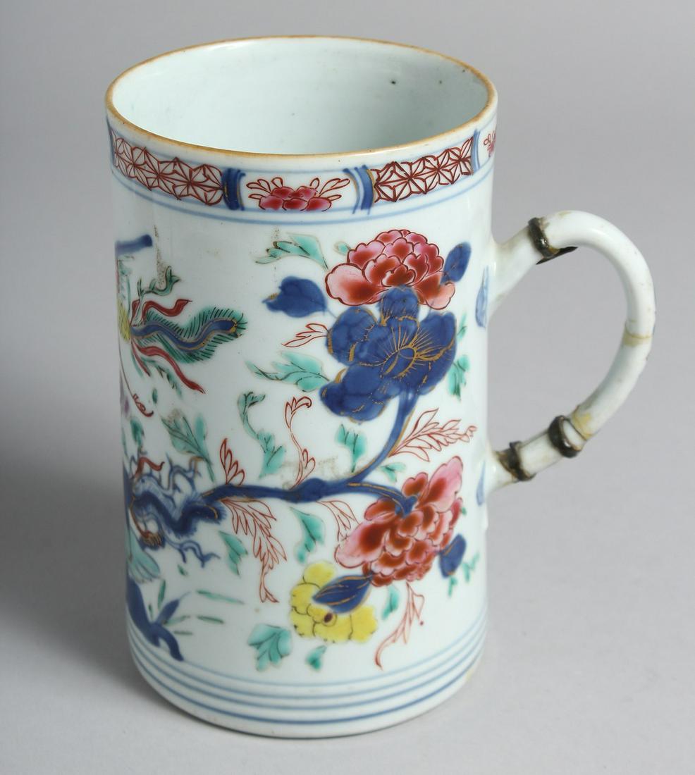 A CHINESE FAMILLE ROSE PORCELAIN TANKARD painted with floral sprays and exotic bird. 14.5cm high: A CHINESE FAMILLE ROSE PORCELAIN TANKARD painted with floral sprays and exotic bird. 14.5cm high