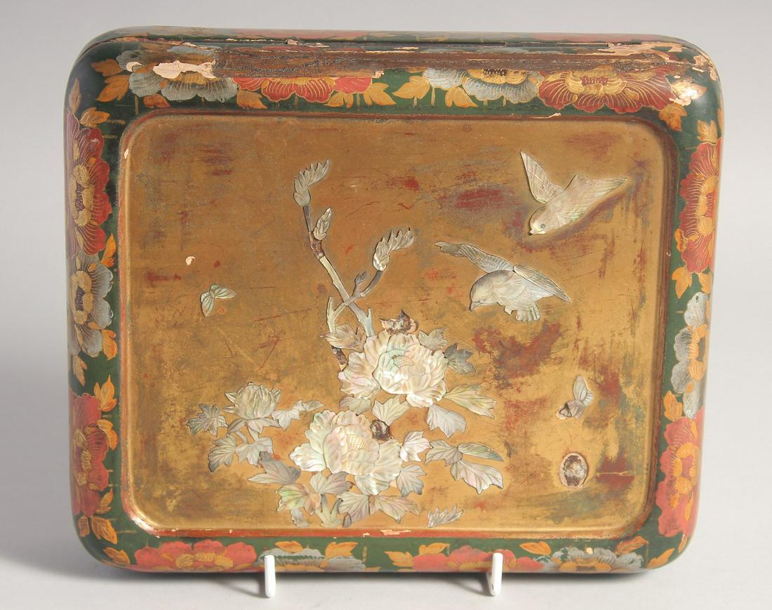 A JAPANESE LACQUERED WOOD AND MOTHER OF PEARL INLAID BOX, the hinged lid with mother of pearl flora,: A JAPANESE LACQUERED WOOD AND MOTHER OF PEARL INLAID BOX, the hinged lid with mother of pearl flora, birds, and gilt decoration, 22.5cm x 19.5cm.