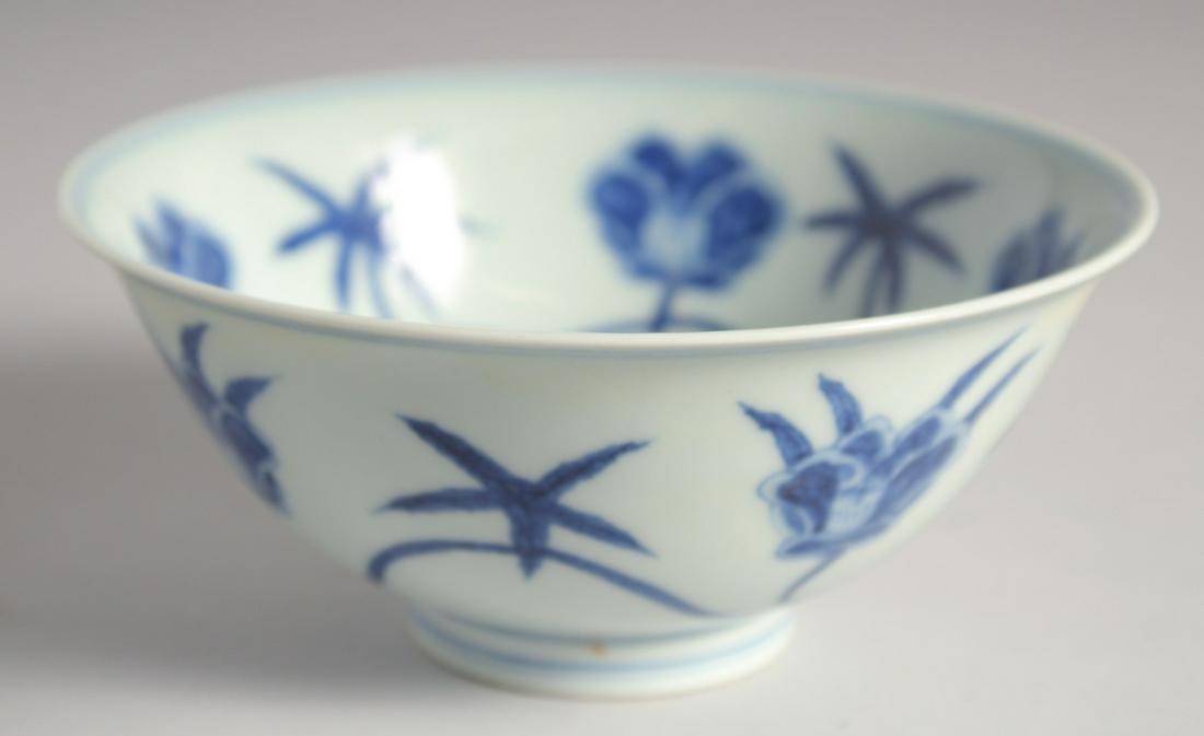 A CHINESE BLUE AND WHITE PORCELAIN BOWL, decorated with large flower heads, 15cm diameter. (1 of 4)