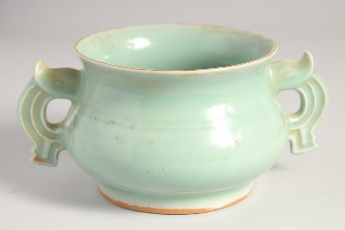 A CHINESE CELADON GLAZE TWIN HANDLE CENSER, 20cm wide (handle to handle).: A CHINESE CELADON GLAZE TWIN HANDLE CENSER, 20cm wide (handle to handle).